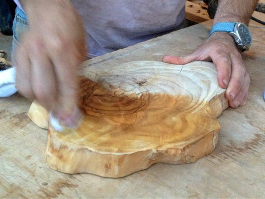 An olive tree slice, gets coated with Forberz Wood Finish quick and easy, no dripping, no chemical smell, just 100% natural honey extracts with no silicone or solvents to protect your wood pieces and give them the perfect look of wet fresh wood while leaving the treated surfaces smooth and dry to the touch